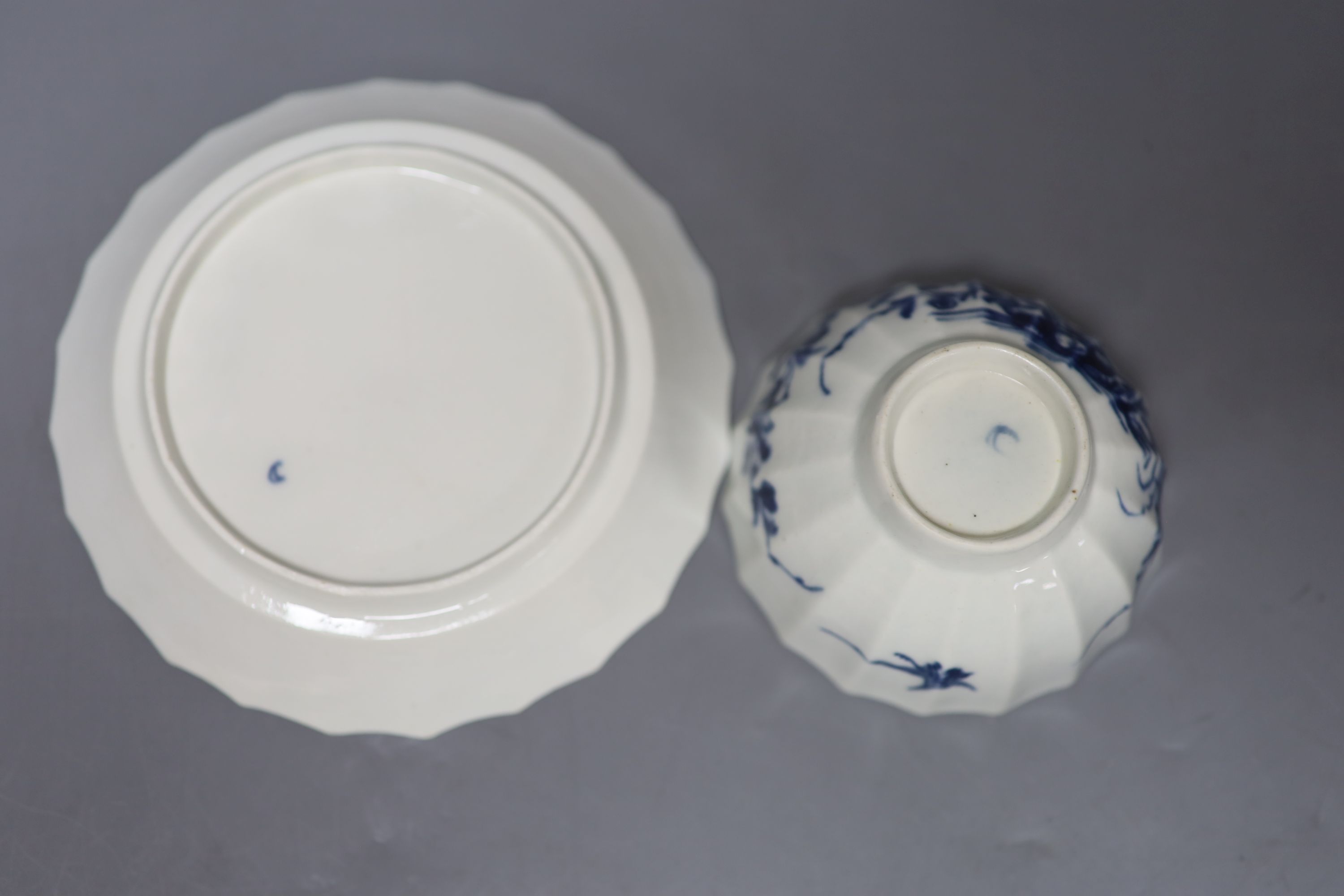 An 18th century Worcester tea bowl and saucer painted with the Hollow Rock Lily pattern, crescent marks